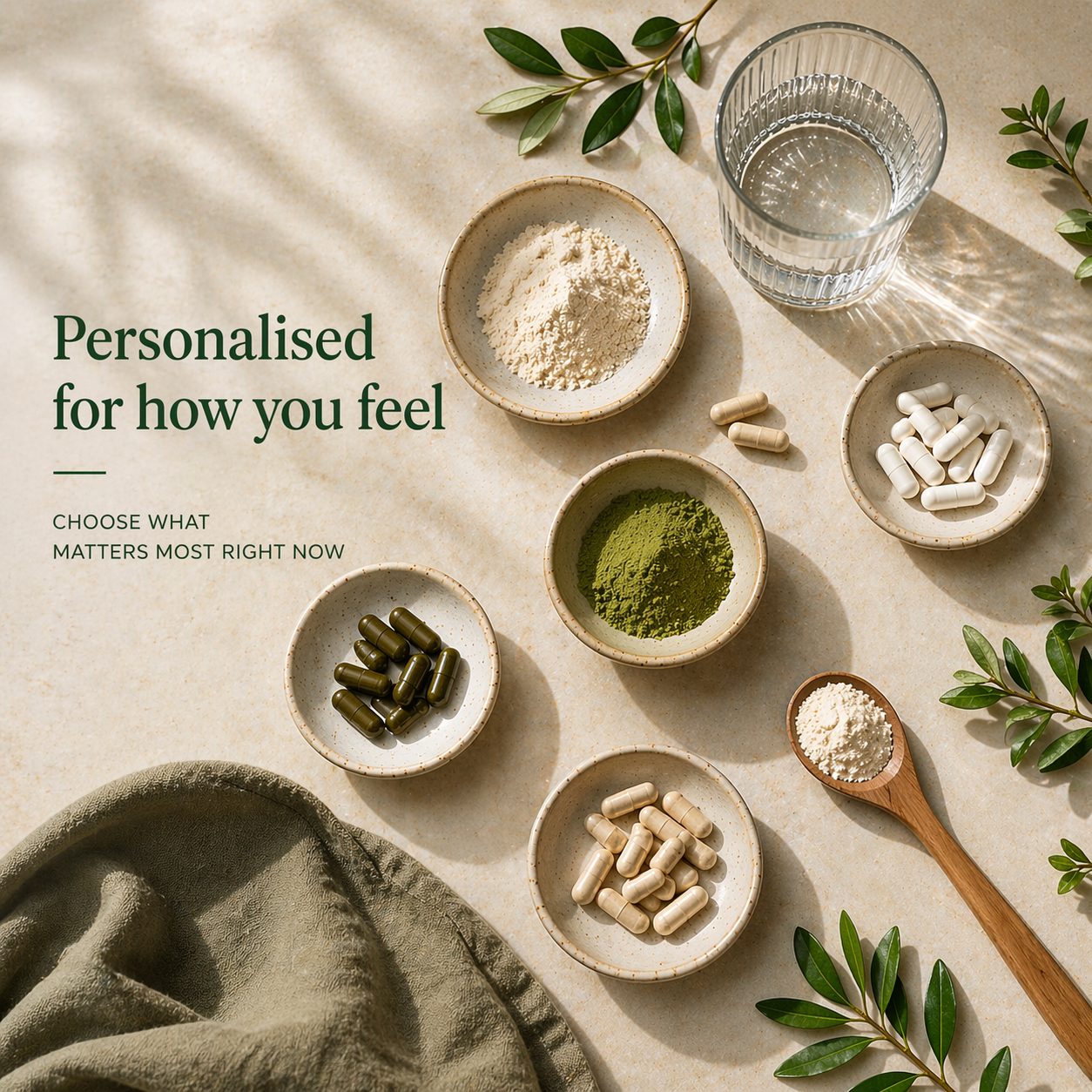 Capsules and powders in small ceramic bowls on a stone surface with leaves